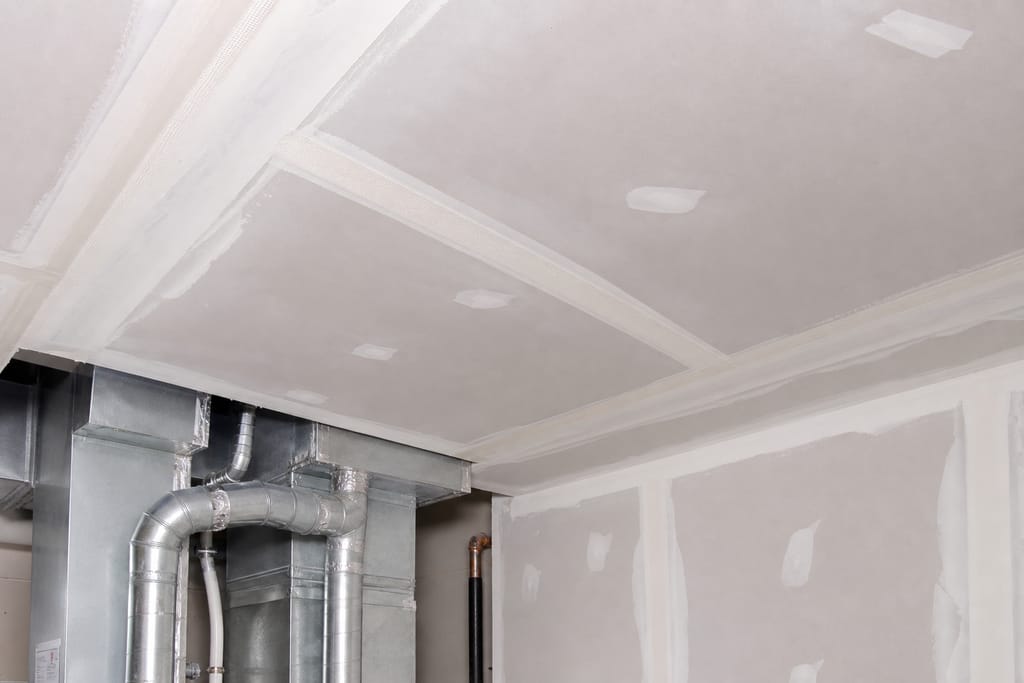 Mesh tape for angled ceiling joints, paper tape for flat runs photo
